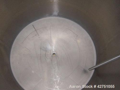 Used Tank, 1000 Gallon, 304 Stainless Steel, Vertical. 66" Diameter x 66" straight side, dished top, coned bottom. Openings top 1-1/2", (2) 2" NPT, (2) 3", 18" man way with cover. 2" Tri-clamp center...