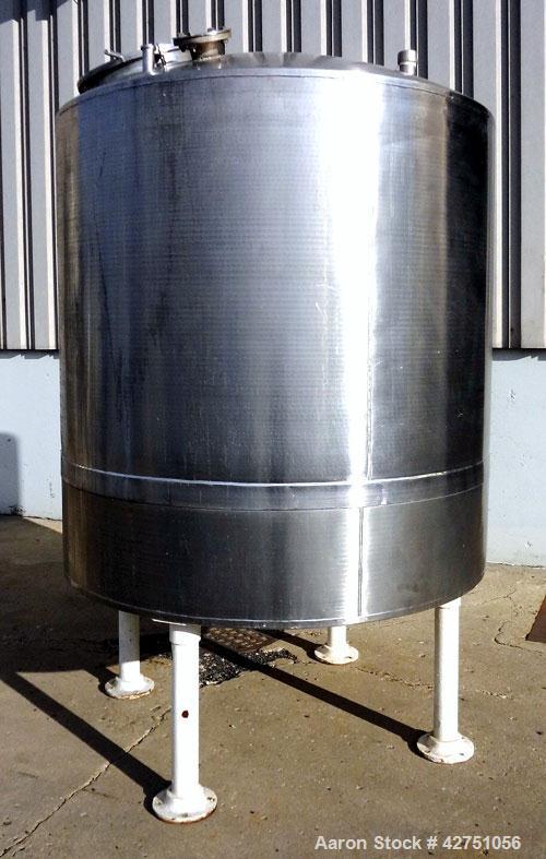Used Tank, 1000 Gallon, 304 Stainless Steel, Vertical. 66" Diameter x 66" straight side, dished top, coned bottom. Openings top 1-1/2", (2) 2" NPT, (2) 3", 18" man way with cover. 2" Tri-clamp center...