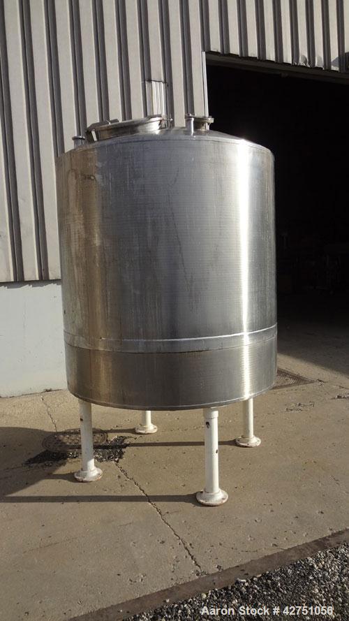 Used Tank, 1000 Gallon, 304 Stainless Steel, Vertical. 66" Diameter x 66" straight side, dished top, coned bottom. Openings top 1-1/2", (2) 2" NPT, (2) 3", 18" man way with cover. 2" Tri-clamp center...