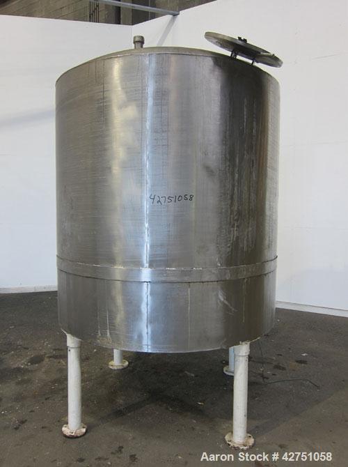 Used Tank, 1000 Gallon, 304 Stainless Steel, Vertical. 66" Diameter x 66" straight side, dished top, coned bottom. Openings top 1-1/2", (2) 2" NPT, (2) 3", 18" man way with cover. 2" Tri-clamp center...