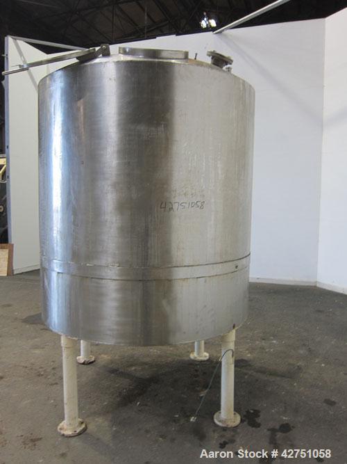 Used Tank, 1000 Gallon, 304 Stainless Steel, Vertical. 66" Diameter x 66" straight side, dished top, coned bottom. Openings top 1-1/2", (2) 2" NPT, (2) 3", 18" man way with cover. 2" Tri-clamp center...