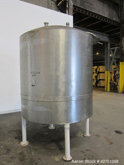 Used Tank, 1000 Gallon, 304 Stainless Steel, Vertical. 66" Diameter x 66" straight side, dished top, coned bottom. Openings top 1-1/2", (2) 2" NPT, (2) 3", 18" man way with cover. 2" Tri-clamp center...