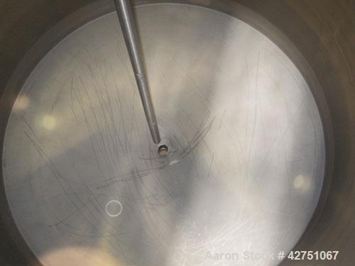 Used Tank, 1000 Gallon, 304 Stainless Steel, Vertical. 66" Diameter x 66" straight side, dished top, coned bottom. Openings top 1-1/2", (2) 2" NPT, (2) 3", 18" man way with cover. 2" Tri-clamp center...