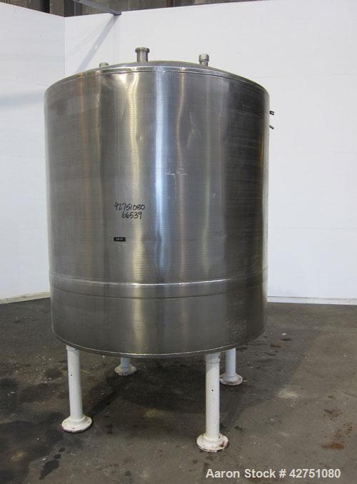 Used Tank, 1000 Gallon, 304 Stainless Steel, Vertical. 66" Diameter x 66" straight side, dished top, coned bottom. Openings top 1-1/2", (2) 2" NPT, (2) 3", 18" man way with cover. 2" Tri-clamp center...