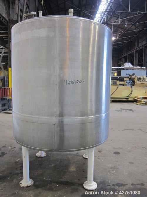 Used Tank, 1000 Gallon, 304 Stainless Steel, Vertical. 66" Diameter x 66" straight side, dished top, coned bottom. Openings top 1-1/2", (2) 2" NPT, (2) 3", 18" man way with cover. 2" Tri-clamp center...