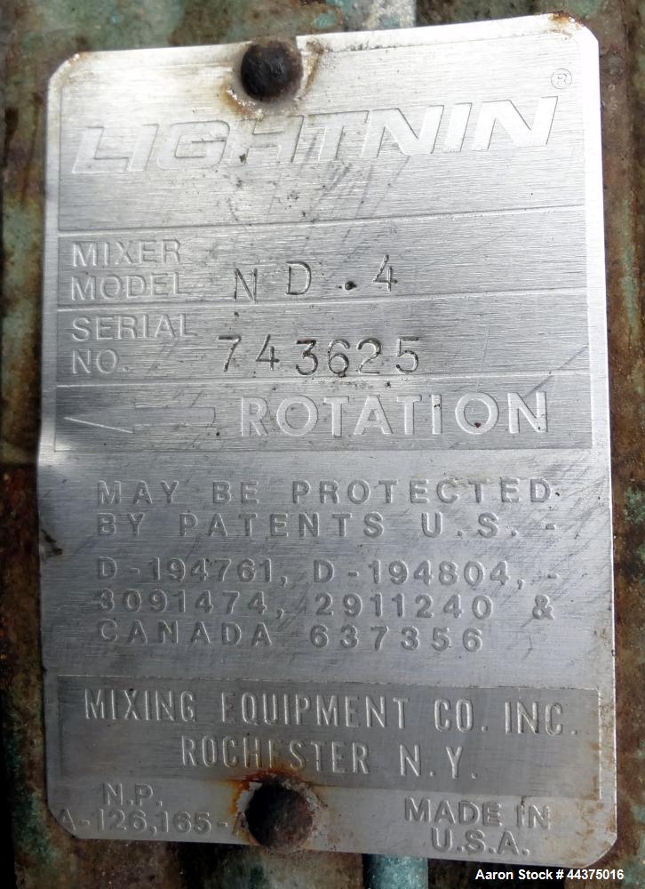 Used Tank, 3000 Gallon, 321 Stainless Steel, Vertical. Approximate 84" diameter x 118" straight side, flat welded top, coned bottom. Fixed carbon steel agitator bridge with a clamp on Lightnin agitat...