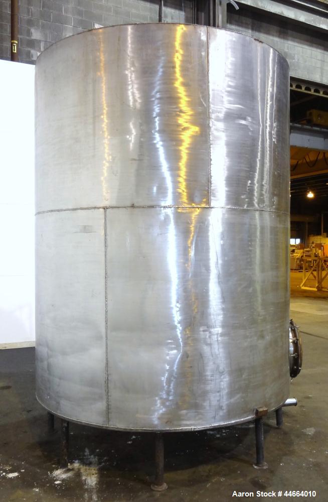 Used Tank, 3000 Gallons, 304 Stainless Steel, Vertical. 90" Diameter x 110" straight side, flat top, dish bottom. (1) Spray ball. Top openings: (1) 20" man way, no cover, (2) 3-1/2", (2) 2", (1) 1.5"...