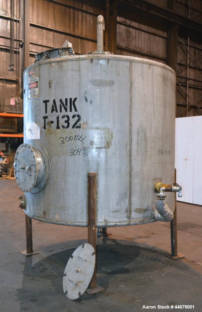 Used Tank, 1800 Gallon, 304 Stainless Steel, Vertical. Approximate 84” diameter x 72” straight side, coned top and bottom. (3) Turns of approximate 2” internal  pipe coil, no rating. (4) Sidewall baf...