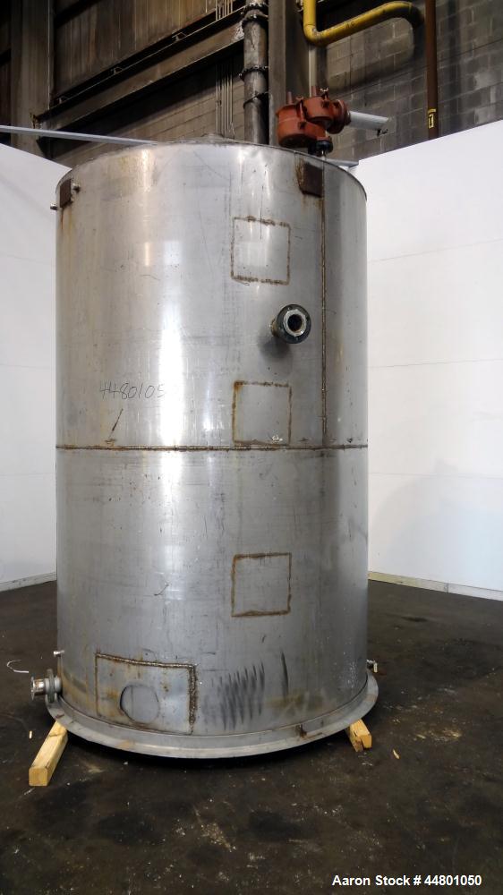 Used Tank, 2300 Gallons, 304 Stainless Steel, Vertical. Approximately 76" diameter x 120" straight side, coned top, flat bottom, 3" side bottom outlet. Tank has (3) large patches on sidewall.