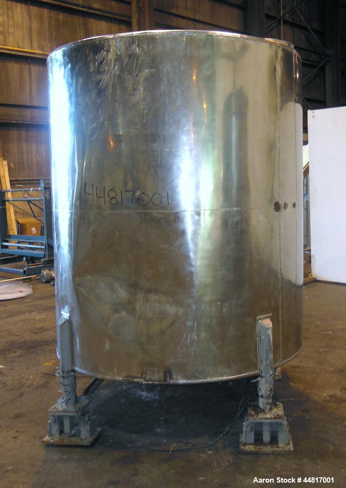 Used Tank, 1000 Gallons, 304 Stainless Steel, Vertical. Approximately 67" diameter x 72" straight side, flat welded top, slight dished bottom. Side bottom entering agitator with a (3) blade prop driv...