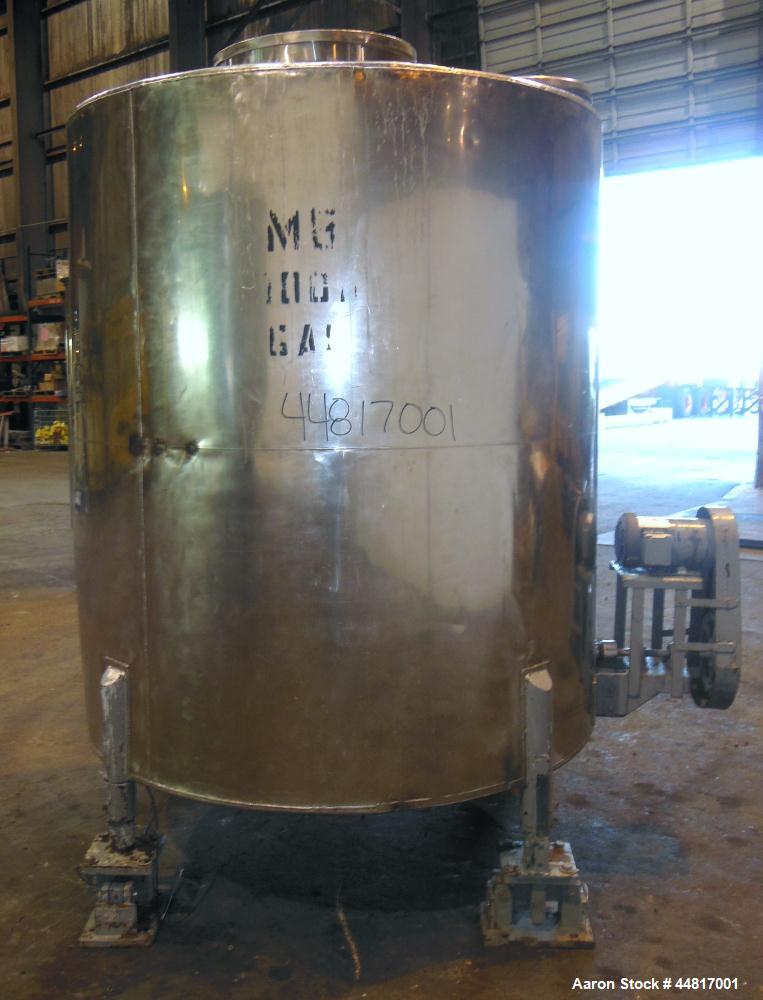 Used Tank, 1000 Gallons, 304 Stainless Steel, Vertical. Approximately 67" diameter x 72" straight side, flat welded top, slight dished bottom. Side bottom entering agitator with a (3) blade prop driv...