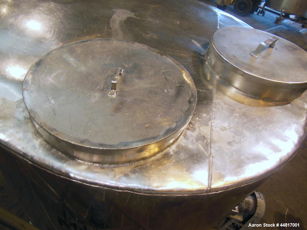 Used Tank, 1000 Gallons, 304 Stainless Steel, Vertical. Approximately 67" diameter x 72" straight side, flat welded top, slight dished bottom. Side bottom entering agitator with a (3) blade prop driv...