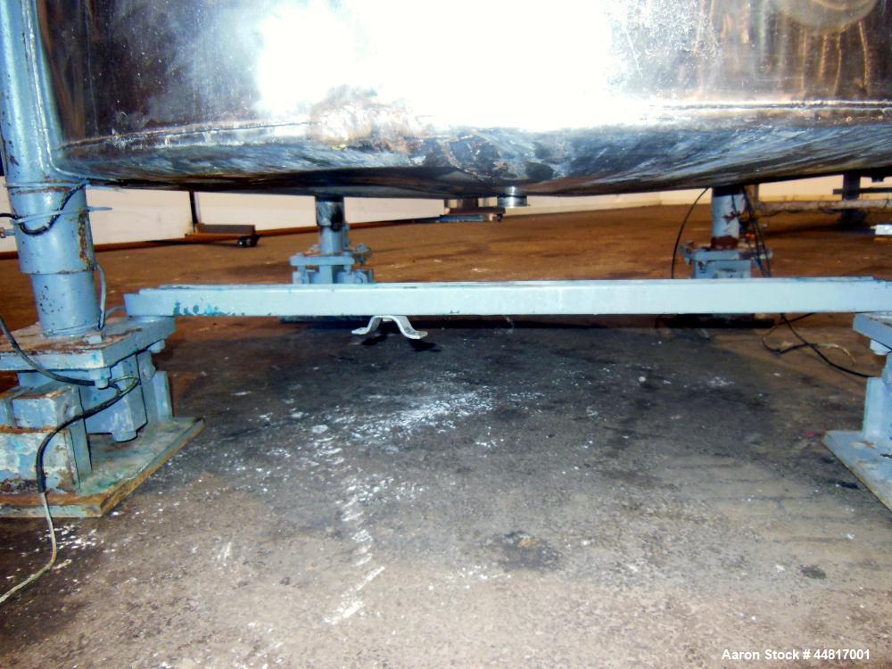 Used Tank, 1000 Gallons, 304 Stainless Steel, Vertical. Approximately 67" diameter x 72" straight side, flat welded top, slight dished bottom. Side bottom entering agitator with a (3) blade prop driv...