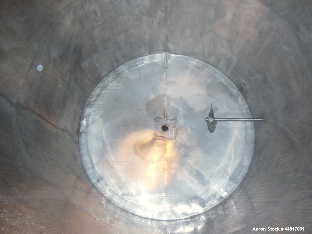 Used Tank, 1000 Gallons, 304 Stainless Steel, Vertical. Approximately 67" diameter x 72" straight side, flat welded top, slight dished bottom. Side bottom entering agitator with a (3) blade prop driv...