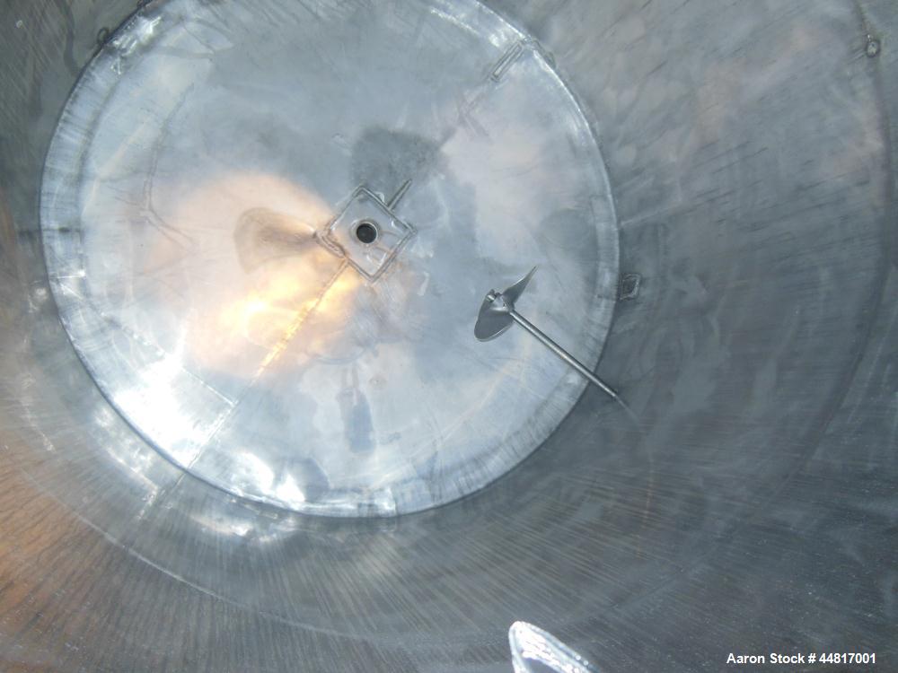 Used Tank, 1000 Gallons, 304 Stainless Steel, Vertical. Approximately 67" diameter x 72" straight side, flat welded top, slight dished bottom. Side bottom entering agitator with a (3) blade prop driv...