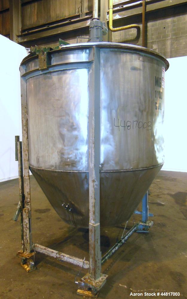 Used Tank, 1000 Gallons, 304 Stainless Steel, Vertical.  Approximately 72" diameter x 42" straight side x 33" cone. Flat open top with (2) 1/2 covers, slight coned bottom.  Fixed carbon steel agitato...