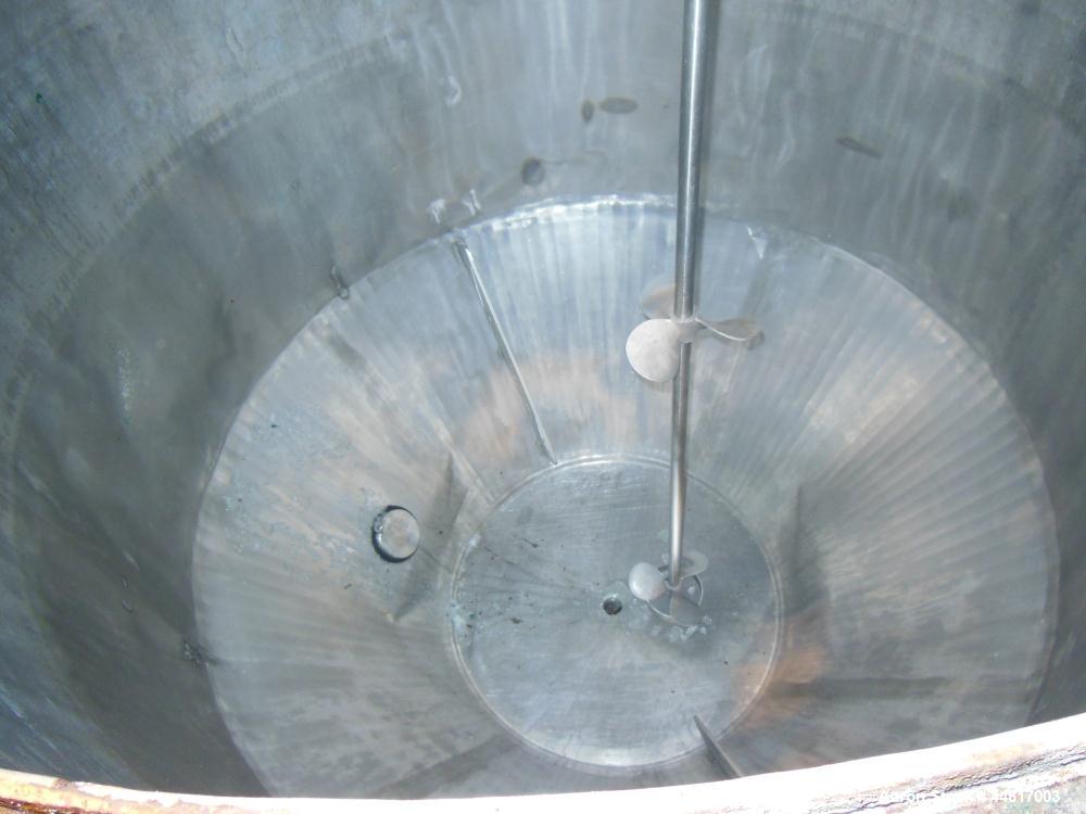 Used Tank, 1000 Gallons, 304 Stainless Steel, Vertical.  Approximately 72" diameter x 42" straight side x 33" cone. Flat open top with (2) 1/2 covers, slight coned bottom.  Fixed carbon steel agitato...