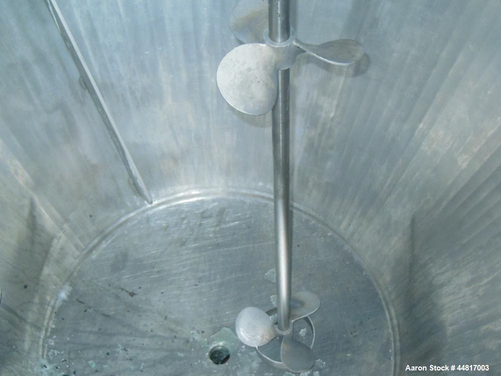 Used Tank, 1000 Gallons, 304 Stainless Steel, Vertical.  Approximately 72" diameter x 42" straight side x 33" cone. Flat open top with (2) 1/2 covers, slight coned bottom.  Fixed carbon steel agitato...