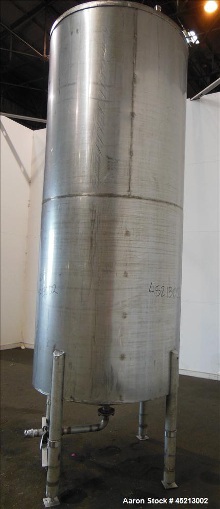 Used Tank, 1100 Gallon, 304 Stainless Steel, Verical. 52" Diameter X 120" straight side. Coned top and bottom. Openings top: 24" X 17" manway with cover, 1 1/2", 2" and 2 1/2".  2 1/2" center bottom ...