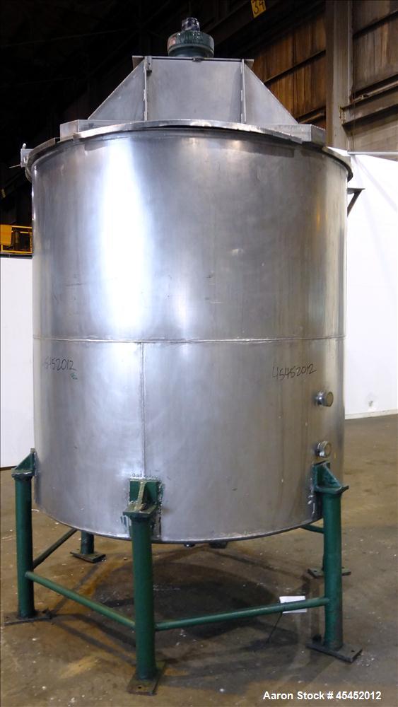 Used Tank, 1,200 Gallons, 304 Stainless Steel, Vertical. Approximate 71" diameter x 71" Straight Side, Flat Top and Dish bottom. Top has agitator bridge  with (3) hinged covers. Lightnin Agitator wit...
