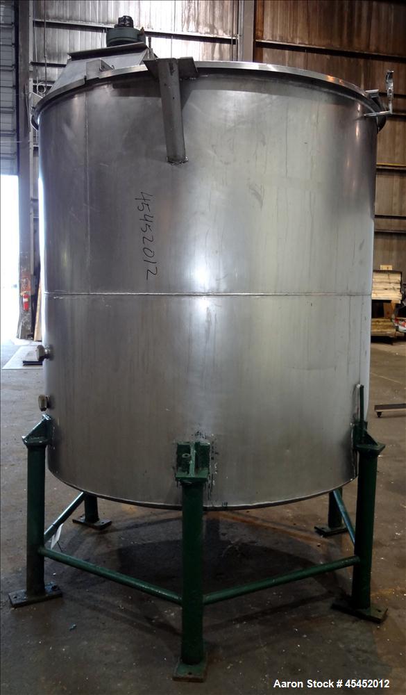 Used Tank, 1,200 Gallons, 304 Stainless Steel, Vertical. Approximate 71" diameter x 71" Straight Side, Flat Top and Dish bottom. Top has agitator bridge  with (3) hinged covers. Lightnin Agitator wit...