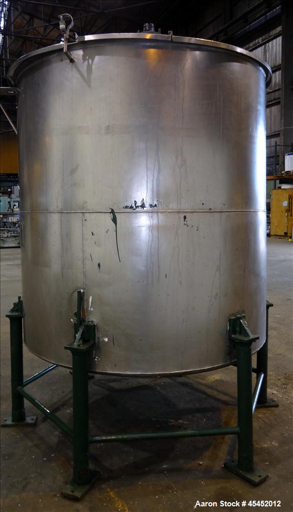 Used Tank, 1,200 Gallons, 304 Stainless Steel, Vertical. Approximate 71" diameter x 71" Straight Side, Flat Top and Dish bottom. Top has agitator bridge  with (3) hinged covers. Lightnin Agitator wit...