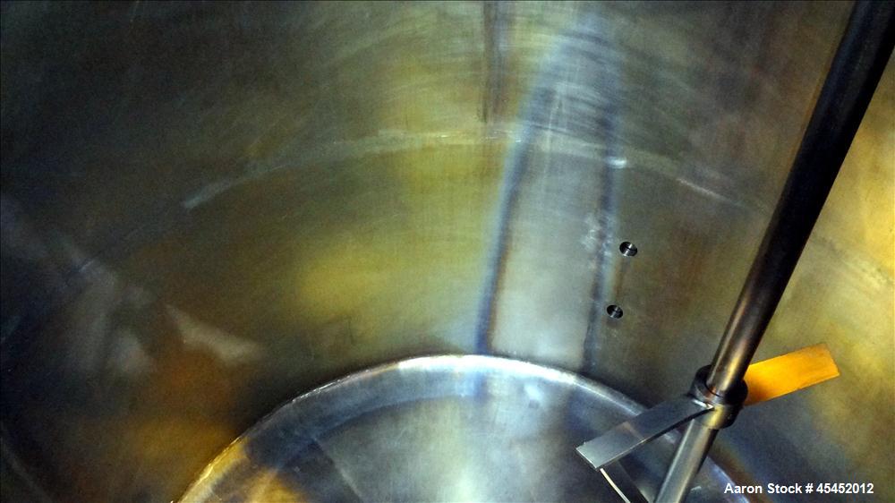 Used Tank, 1,200 Gallons, 304 Stainless Steel, Vertical. Approximate 71" diameter x 71" Straight Side, Flat Top and Dish bottom. Top has agitator bridge  with (3) hinged covers. Lightnin Agitator wit...