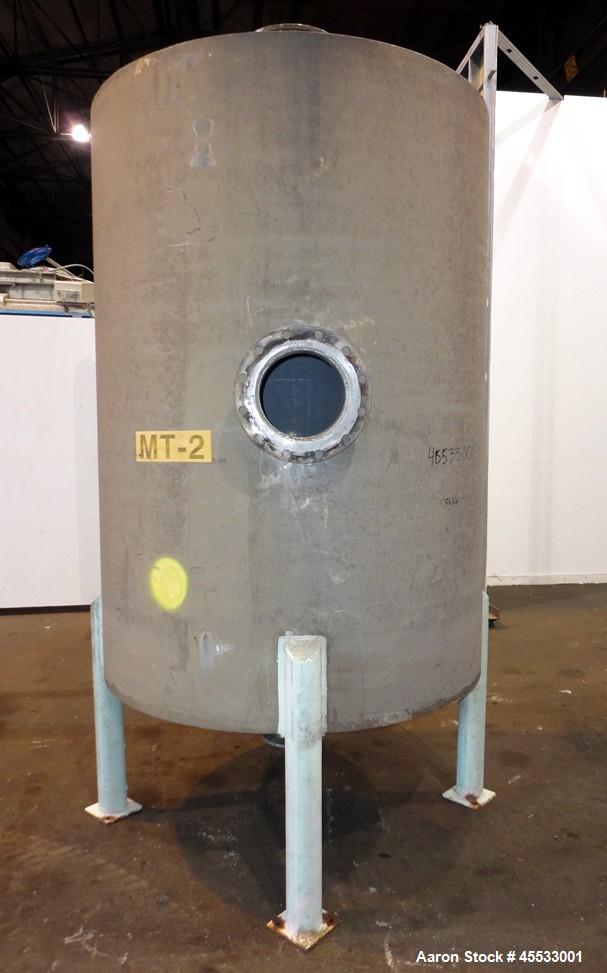 Used 1244 Gallon, 316 Stainless Steel Tank. Approximately 65" diameter x 84" straight side. Dished top and bottom. 10" flange top center opening, 10" side outlet and a 6" center bottom outlet. Mounte...