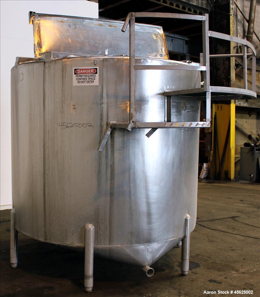 Used Tank, Approximately 2000 Gallons, 304 Stainless Steel, Vertical. Approximately 90" diameter x 74" straight side. Flat top, sloped V-bottom. Has fixed carbon steel agitator mount, no motor, 1-1/2...