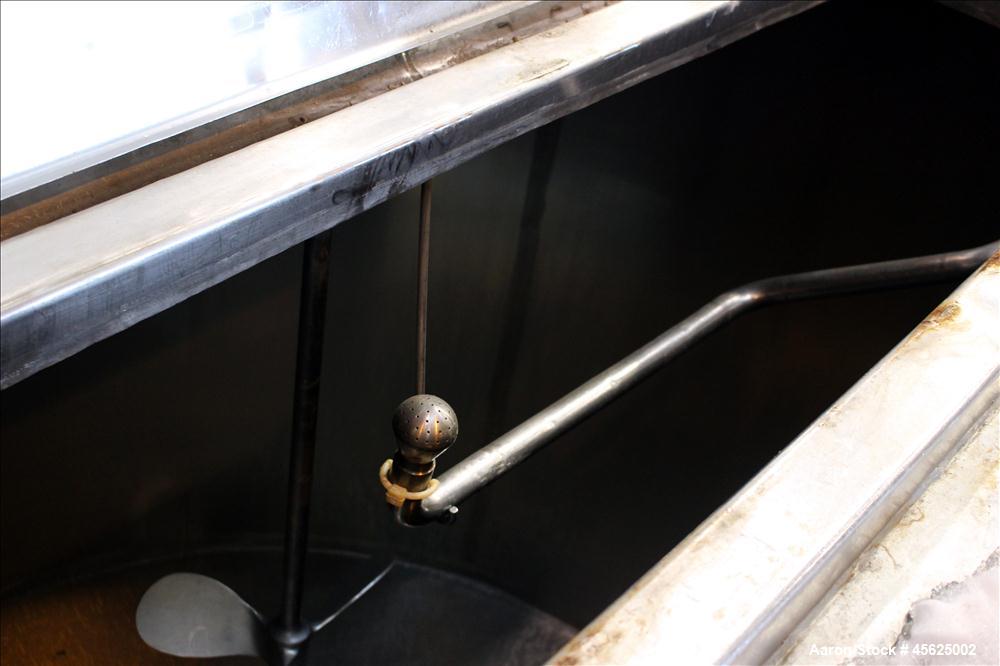Used Tank, Approximately 2000 Gallons, 304 Stainless Steel, Vertical. Approximately 90" diameter x 74" straight side. Flat top, sloped V-bottom. Has fixed carbon steel agitator mount, no motor, 1-1/2...