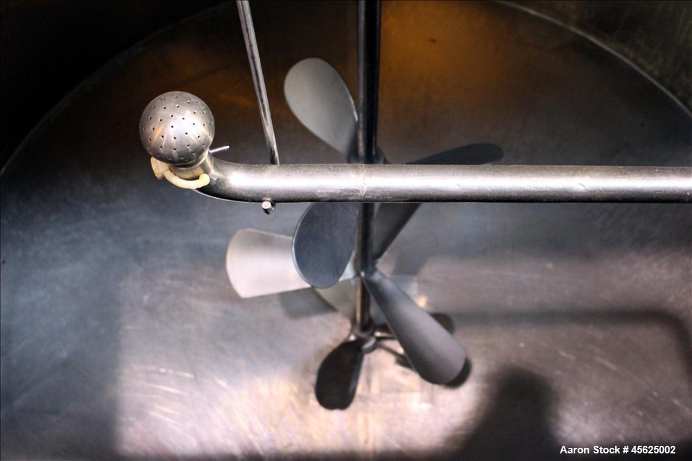 Used Tank, Approximately 2000 Gallons, 304 Stainless Steel, Vertical. Approximately 90" diameter x 74" straight side. Flat top, sloped V-bottom. Has fixed carbon steel agitator mount, no motor, 1-1/2...