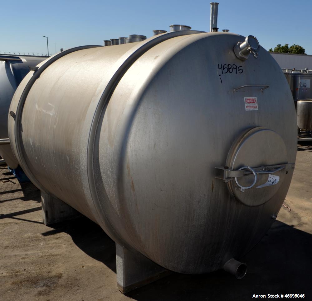 Used Tank, 1400 Gallon, Stainless Steel, Horizontal. 66" Diameter x 82" straight side, dished heads. Openings top (3) 1-1/2", 2", (2) 3", (2) 4", 6", heads 1-1/2", (2) 4" outlets, 18" man way with co...
