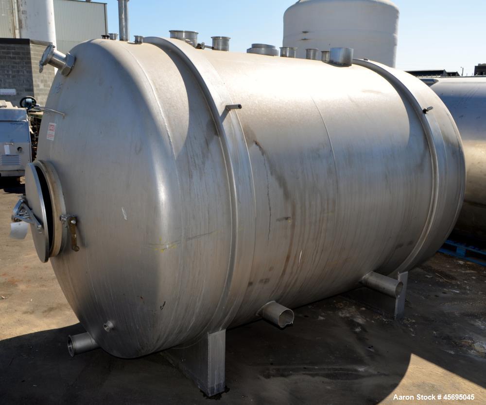 Used Tank, 1400 Gallon, Stainless Steel, Horizontal. 66" Diameter x 82" straight side, dished heads. Openings top (3) 1-1/2", 2", (2) 3", (2) 4", 6", heads 1-1/2", (2) 4" outlets, 18" man way with co...