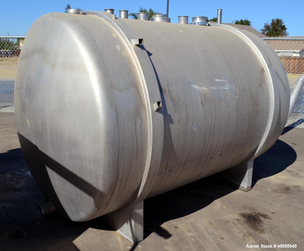 Used Tank, 1400 Gallon, Stainless Steel, Horizontal. 66" Diameter x 82" straight side, dished heads. Openings top (3) 1-1/2", 2", (2) 3", (2) 4", 6", heads 1-1/2", (2) 4" outlets, 18" man way with co...