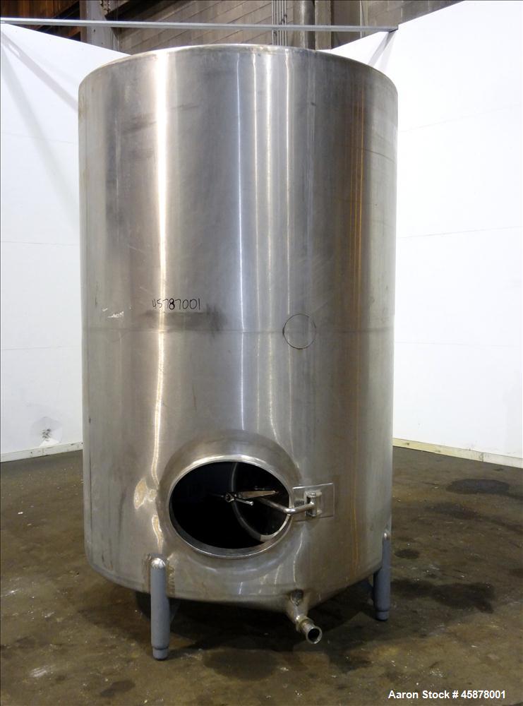 Used Tank, Approximate 1400 Gallons, 304 Stainless Steel, Vertical. Approximate 66" diameter x 93" straight side, dished top, sloped bottom. Top openings 2", 1.5". Side openings 3", 5", 22" man way w...
