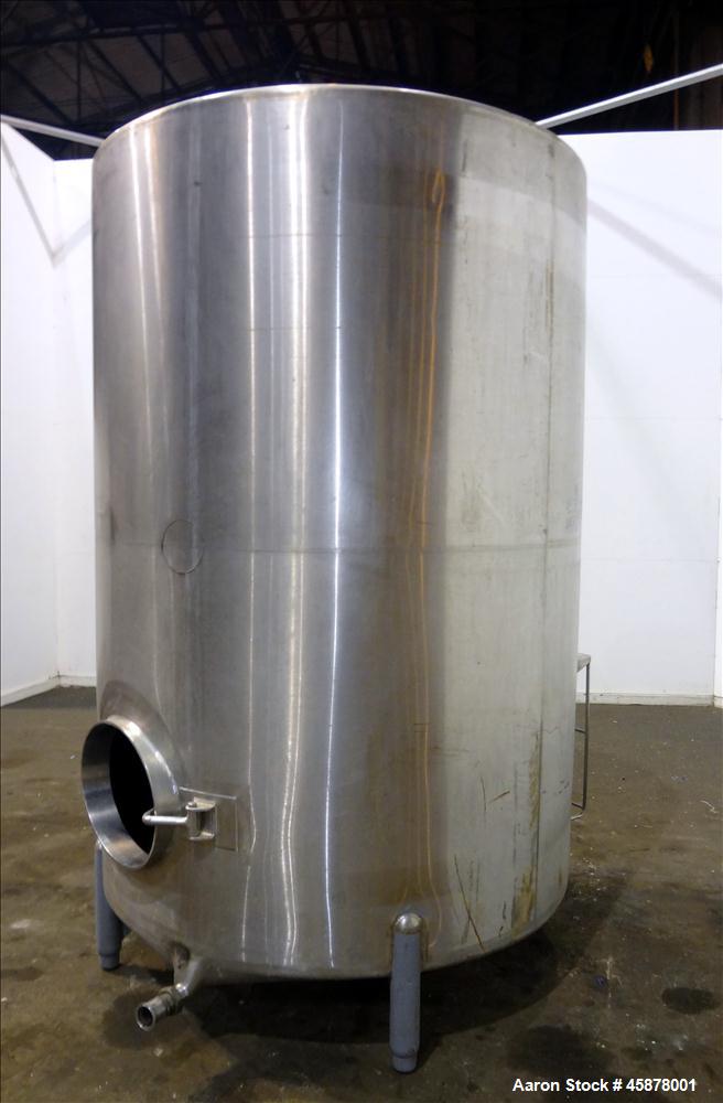 Used Tank, Approximate 1400 Gallons, 304 Stainless Steel, Vertical. Approximate 66" diameter x 93" straight side, dished top, sloped bottom. Top openings 2", 1.5". Side openings 3", 5", 22" man way w...