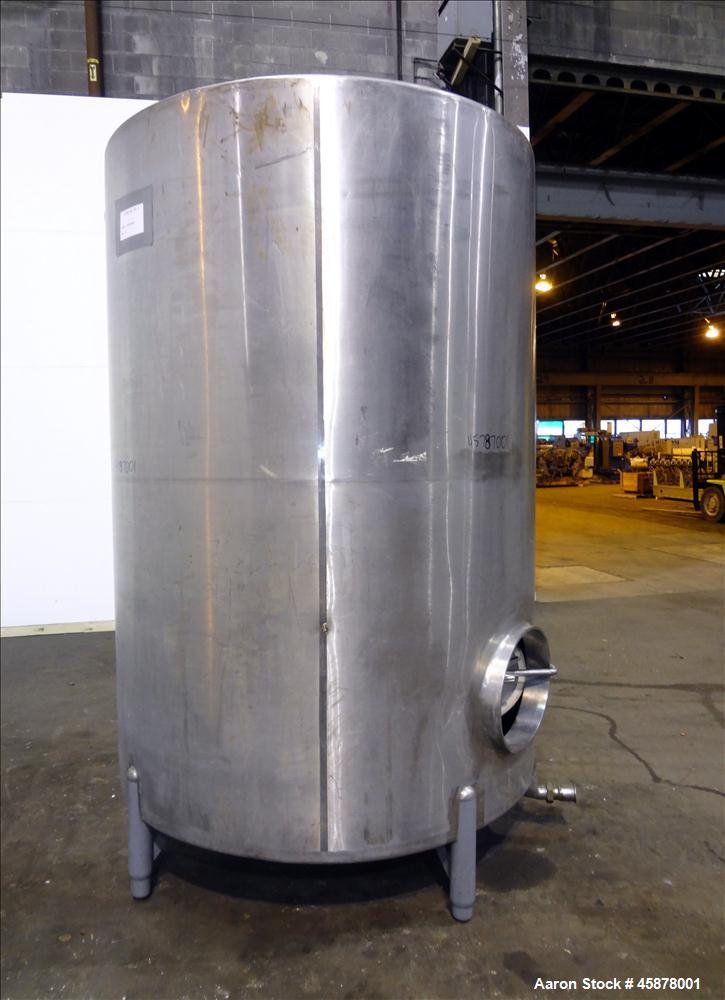 Used Tank, Approximate 1400 Gallons, 304 Stainless Steel, Vertical. Approximate 66" diameter x 93" straight side, dished top, sloped bottom. Top openings 2", 1.5". Side openings 3", 5", 22" man way w...
