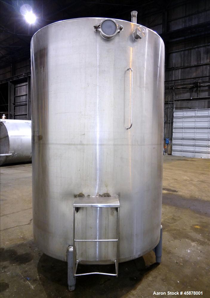 Used Tank, Approximate 1400 Gallons, 304 Stainless Steel, Vertical. Approximate 66" diameter x 93" straight side, dished top, sloped bottom. Top openings 2", 1.5". Side openings 3", 5", 22" man way w...