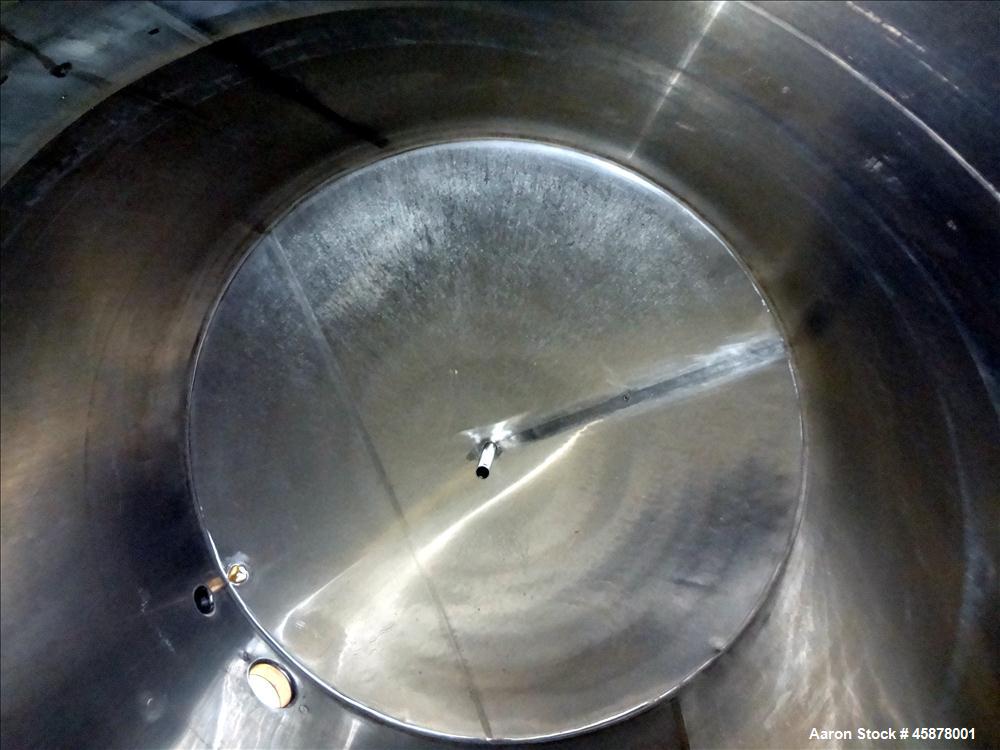 Used Tank, Approximate 1400 Gallons, 304 Stainless Steel, Vertical. Approximate 66" diameter x 93" straight side, dished top, sloped bottom. Top openings 2", 1.5". Side openings 3", 5", 22" man way w...