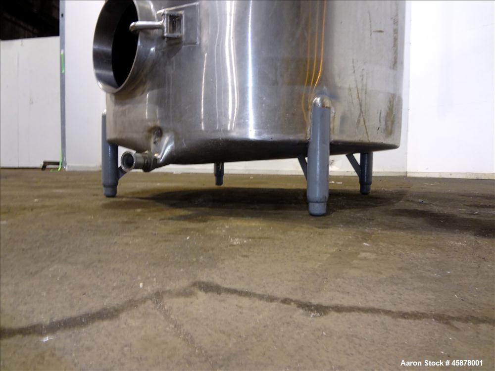 Used Tank, Approximate 1400 Gallons, 304 Stainless Steel, Vertical. Approximate 66" diameter x 93" straight side, dished top, sloped bottom. Top openings 2", 1.5". Side openings 3", 5", 22" man way w...