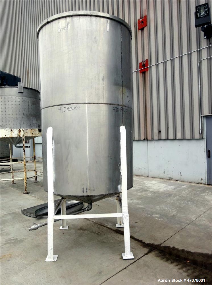 Used Tank, Approximate 1,000 Gallon, 304 Stainless Steel, Vertical. Approximate 56" diameter x 94" straight side. Open top with covers, coned bottom. 2" Center bottom outlet. Mounted on (4) carbon st...