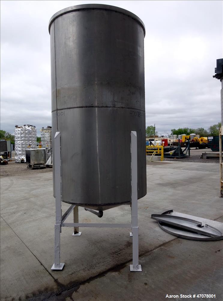 Used Tank, Approximate 1,000 Gallon, 304 Stainless Steel, Vertical. Approximate 56" diameter x 94" straight side. Open top with covers, coned bottom. 2" Center bottom outlet. Mounted on (4) carbon st...