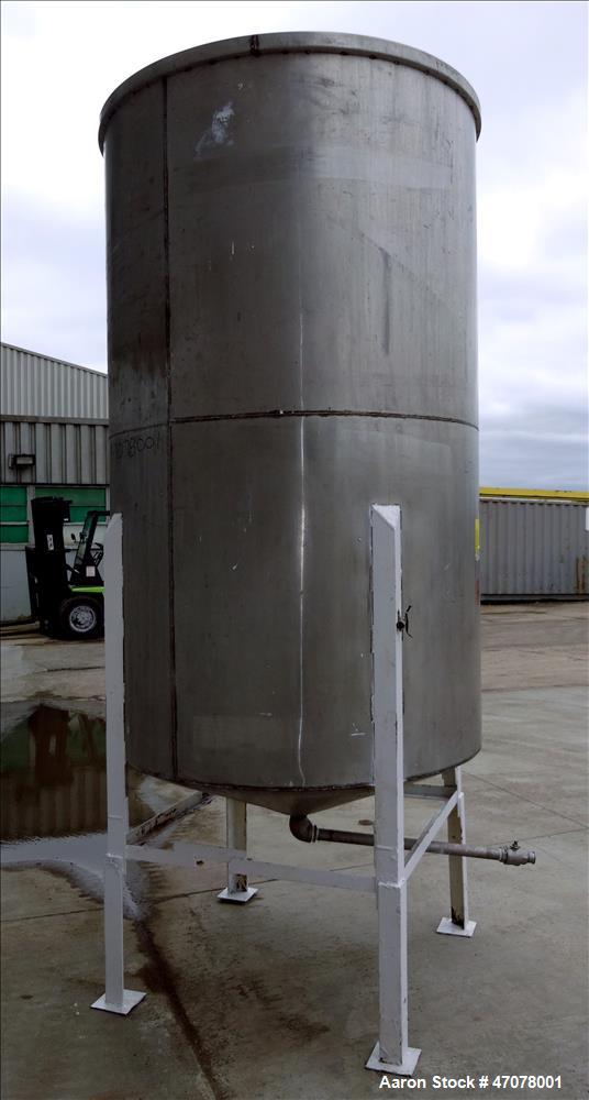 Used Tank, Approximate 1,000 Gallon, 304 Stainless Steel, Vertical. Approximate 56" diameter x 94" straight side. Open top with covers, coned bottom. 2" Center bottom outlet. Mounted on (4) carbon st...