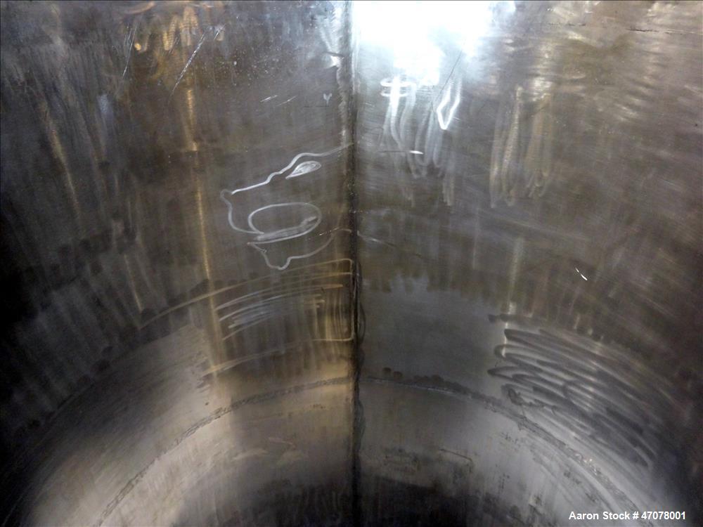 Used Tank, Approximate 1,000 Gallon, 304 Stainless Steel, Vertical. Approximate 56" diameter x 94" straight side. Open top with covers, coned bottom. 2" Center bottom outlet. Mounted on (4) carbon st...