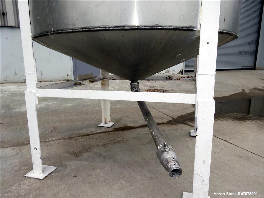 Used Tank, Approximate 1,000 Gallon, 304 Stainless Steel, Vertical. Approximate 56" diameter x 94" straight side. Open top with covers, coned bottom. 2" Center bottom outlet. Mounted on (4) carbon st...