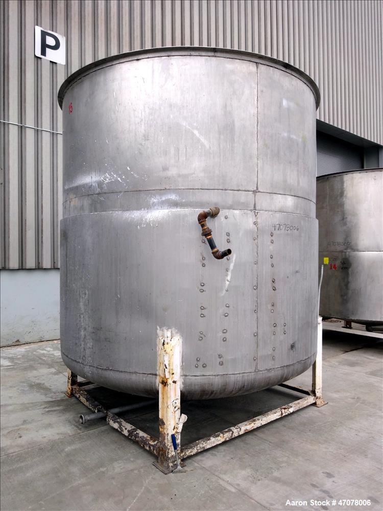 Used Tank, Approximate 4500 Gallon, Stainless Steel, Vertical. Approximate 114" diameter x 106" straight side. Open top with lift off cover, dished bottom.  2" Center bottom outlet. Mounted on 4 carb...