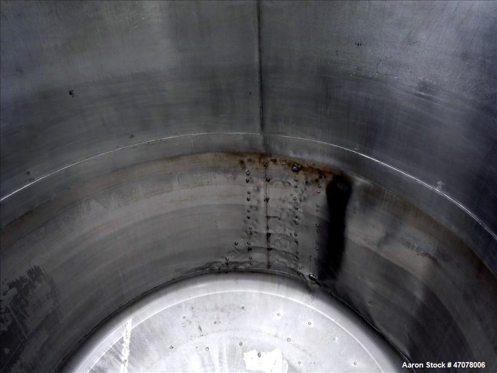 Used Tank, Approximate 4500 Gallon, Stainless Steel, Vertical. Approximate 114" diameter x 106" straight side. Open top with lift off cover, dished bottom.  2" Center bottom outlet. Mounted on 4 carb...