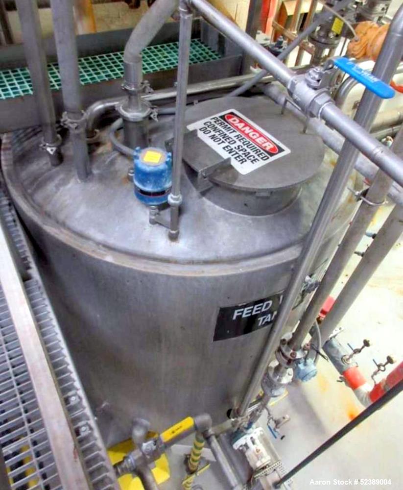 Used 1200 Gallon Stainless Steel Tank, Vertical. Approximate 66" diameter x 80" deep. Dished top & bottom heads. Openings top: 20" diameter manway with cover, (1) 4" tri-clamp reduced to 2", (1) 3" d...