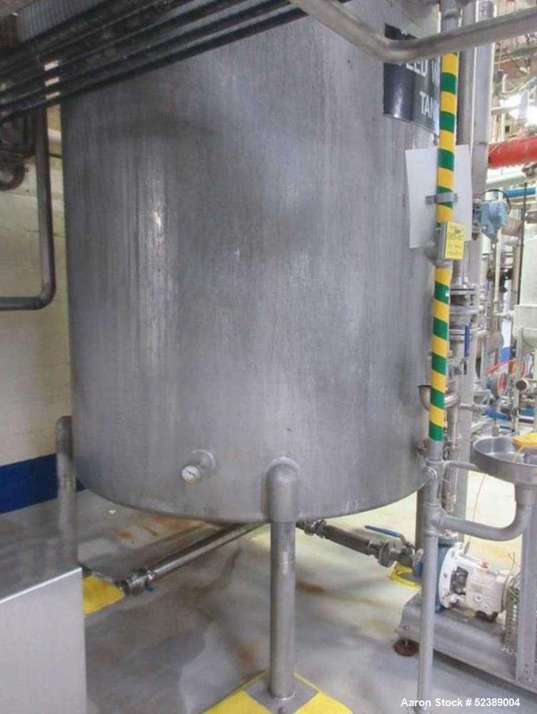 Used 1200 Gallon Stainless Steel Tank, Vertical. Approximate 66" diameter x 80" deep. Dished top & bottom heads. Openings top: 20" diameter manway with cover, (1) 4" tri-clamp reduced to 2", (1) 3" d...