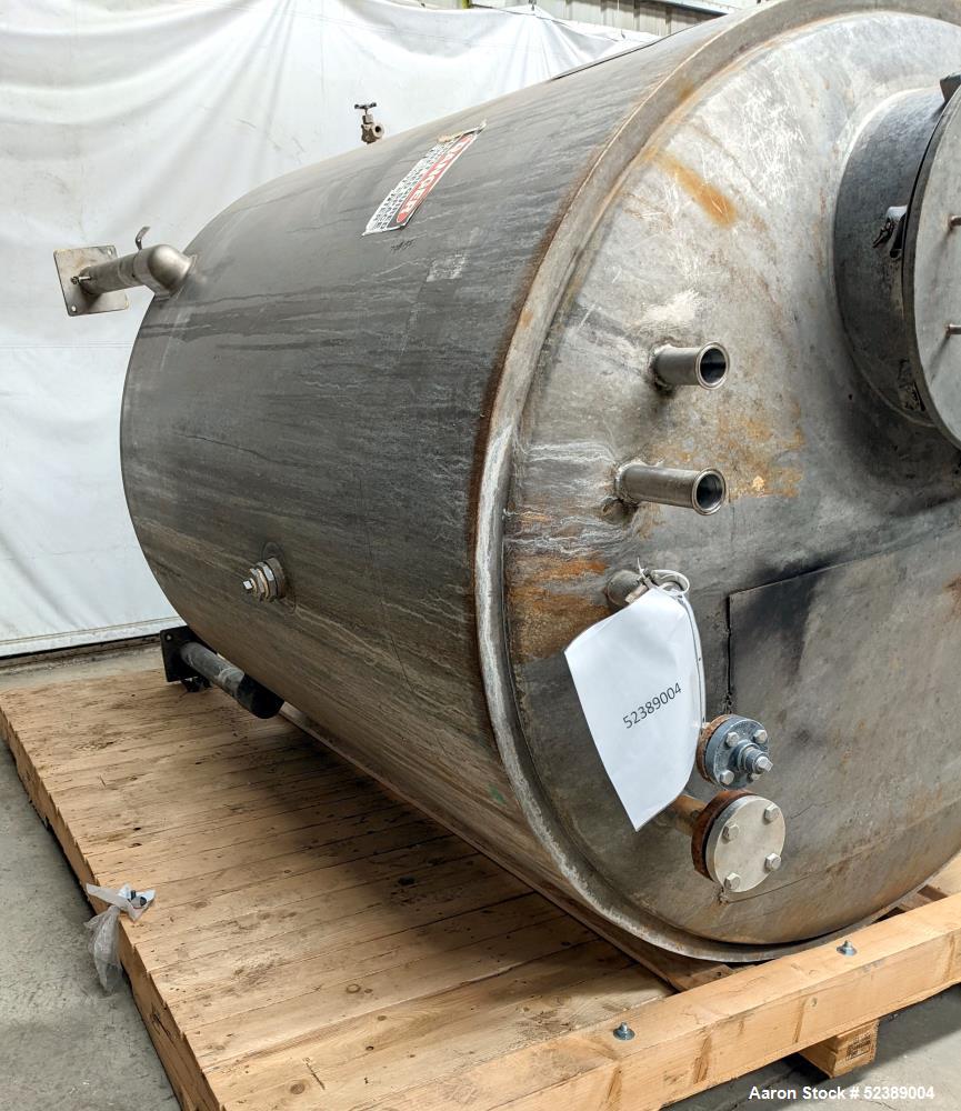 Used 1200 Gallon Stainless Steel Tank, Vertical. Approximate 66" diameter x 80" deep. Dished top & bottom heads. Openings top: 20" diameter manway with cover, (1) 4" tri-clamp reduced to 2", (1) 3" d...